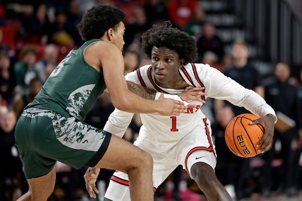 St. John's guard Kadary Richmond (1) looks to drive around Wagner guard Ja'Kair Sanchez during the second half of an NCAA college basketball game Wednesday, Nov. 13, 2024, in New York. St. John's won 66-45. (AP Photo/Adam Hunger)