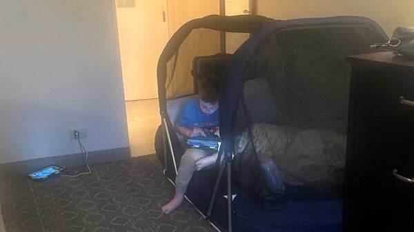 Jaxton Humphries, 7, hangs out in his bed at a hotel the night before his appointment at the Marcus Autism Center. (Courtesy of Monique Humphries).