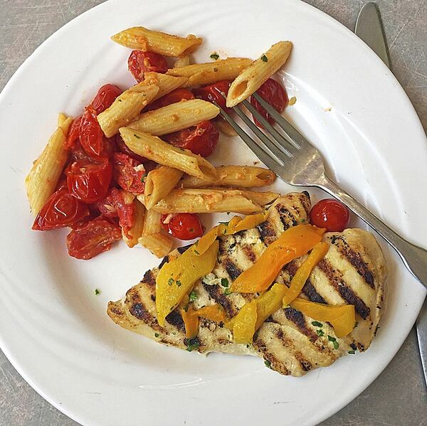 Grilled chicken with peppers, and pasta Parmesan with cherry tomatoes are on the menu at the Steelers summer training camp at the Community Center Dining Hall at Saint Vincent College in Latrobe. (Gretchen McKay/Pittsburgh Post-Gazette/TNS)