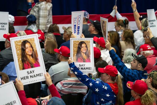  FILE — Attendees hold signs bearing a photo of Laken Riley during a rally for former President Donald Trump earlier this month in Rome. A Venezuelan national who authorities say entered the country illegally has been charged with murder in Riley's death. The case helped drive a push for immigration legislation during the General Assembly's legislative session that just ended. (Nicole Craine/The New York Times) 