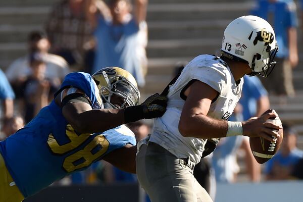 UCLA’s Takkarist McKinley sacks Colorado quarterback Serfo Liufau in the fourth quarter of their 2015 game. (Lisa Blumenfeld/Getty Images)