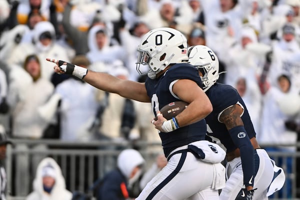 Penn State linebacker Dominic DeLuca celebrates an interception for a touchdown against SMU during the first half in the first round of the NCAA College Football Playoff, Saturday, Dec. 21, 2024, in State College, Pa. (AP Photo/Barry Reeger)