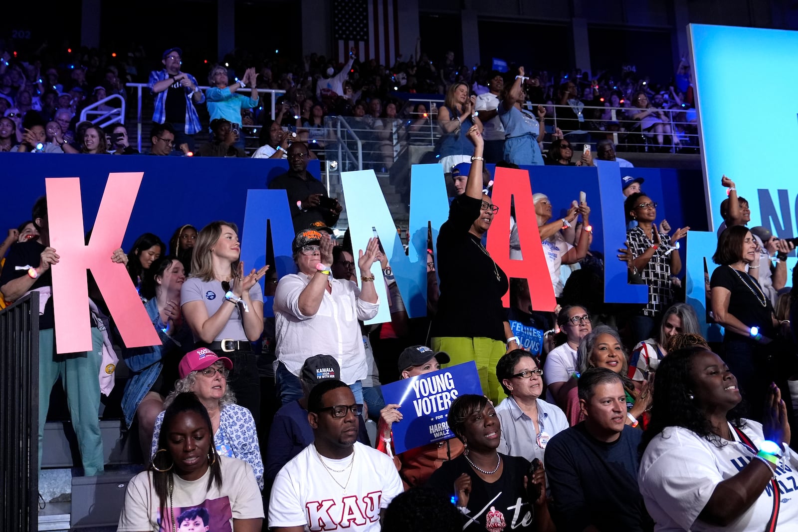 Attendees are pictured in the audience before Democratic presidential nominee Vice President Kamala Harris arrives to speak at a campaign rally at East Carolina University in Greenville, N.C., Sunday, Oct. 12, 2024. (AP Photo/Susan Walsh)