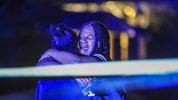 Friends and family members of Nicholas Bankston grieve at the scene of where he was shot and killed on Feb. 22, 2018. (JOHN SPINK/JSPINK@AJC.COM)