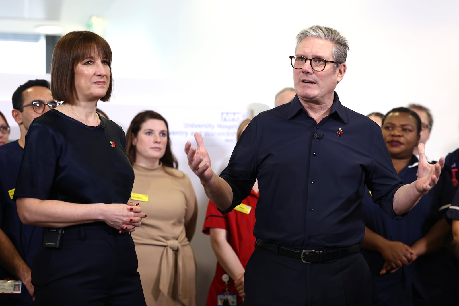 Britain's Prime Minister Keir Starmer and Chancellor Rachel Reeves speak with members of staff, during a visit to University Hospital Coventry and Warwickshire, in Coventry, England, Thursday, Oct. 31, 2024. (AP Photo/Darren Staples, pool)