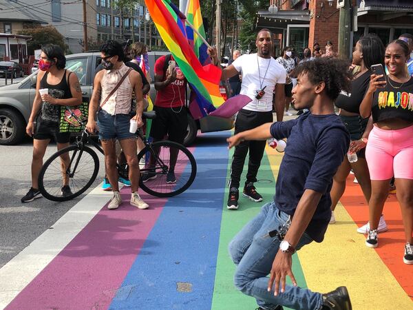 Rashad ‘Boone, of Atlanta, danced in the rainbow crosswalk at 10th Street and Piedmont Avenue on Sunday, June 28, 2020, during a rally for racial and social justice commemorating the 51st anniversary of the Stonewall riots. DAVID WICKERT/DWICKERT@AJC.COM