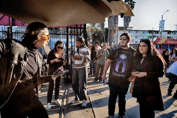 Movie fans pick out tee-shirts during a merchandise Pop-Up event for the newly released film Anora on Saturday, Nov. 9, 2024 in Los Angeles. (AP Photo/Richard Vogel)