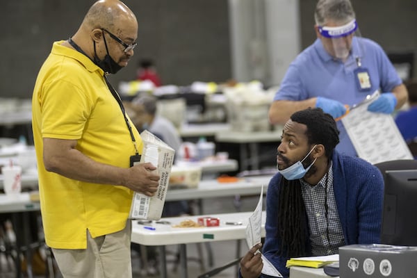 Fulton County employees continue to count mail-in ballots at the Georgia World Congress Center in Atlanta the day after the state’s primary election. (ALYSSA POINTER / ALYSSA.POINTER@AJC.COM)