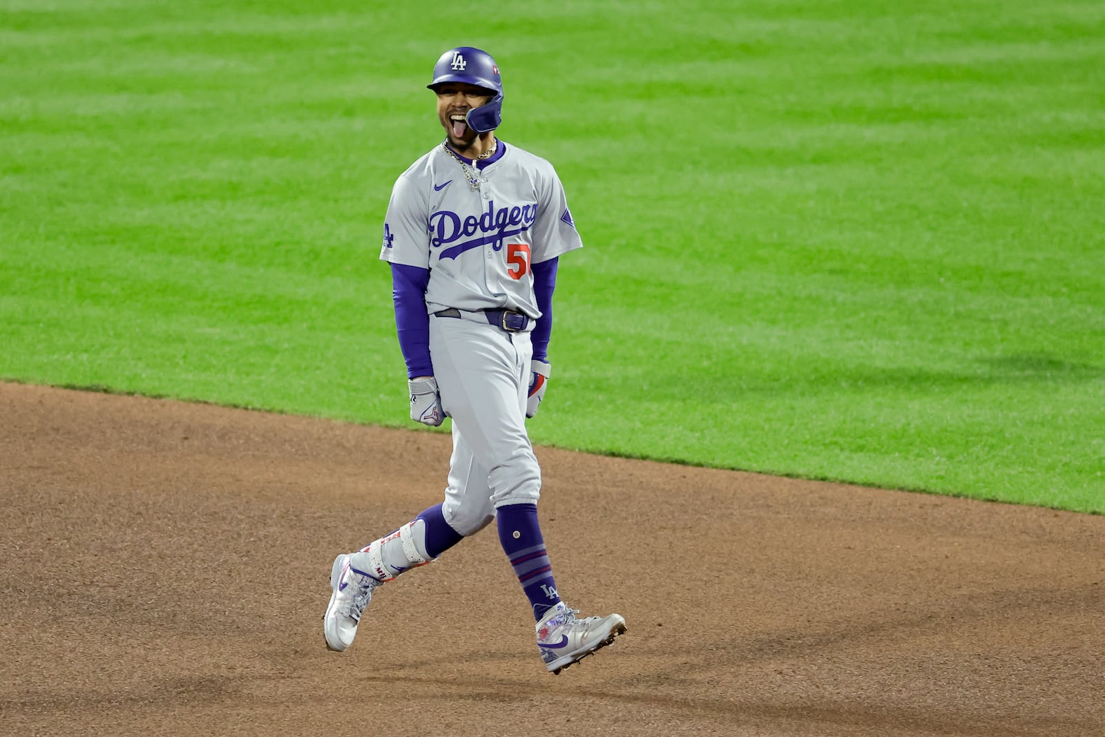 Los Angeles Dodgers' Mookie Betts celebrates after a two run double against the New York Mets during the fourth inning in Game 4 of a baseball NL Championship Series, Thursday, Oct. 17, 2024, in New York. (AP Photo/Adam Hunger)