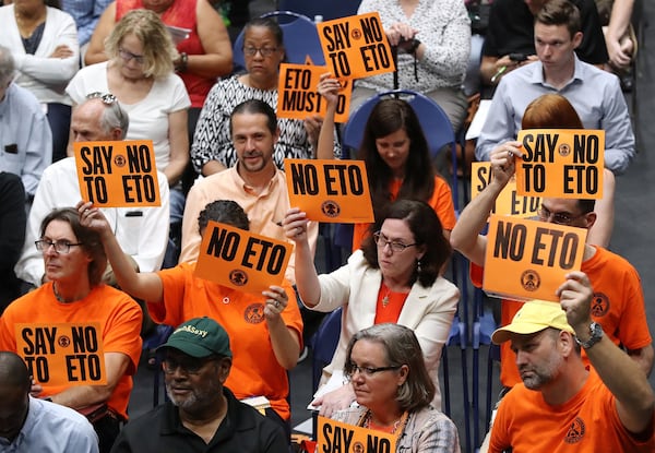 Neighbors of a Cobb County medical equipment sterilization plant hold “NO ETO” signs at a town hall Monday. The forum was held following reports that two Fulton census tracts have high levels of carcinogenic gas emissions. CURTIS COMPTON / CCOMPTON@AJC.COM