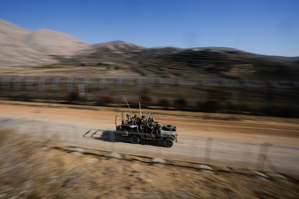 Israeli soldiers stand on an armored vehicle after crossing the security fence along the so-called Alpha Line that separates the Israeli-controlled Golan Heights from Syria, in the town of Majdal Shams, Tuesday, Dec. 17, 2024. (AP Photo/Matias Delacroix)