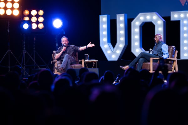 Dave Matthews, left, campaigned Monday for U.S. Sen. Raphael Warnock at an event aimed at suburban white voters.  Ben Gray for The Atlanta Journal-Constitution