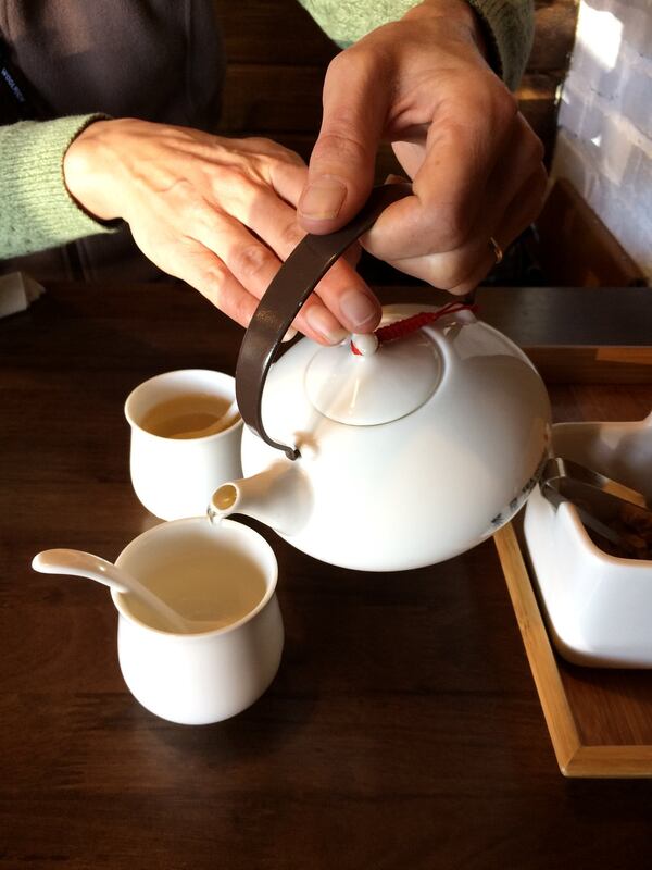 The rituals of tea make a visit to Tea House Formosa a fun and exciting discovery. Here a guest pours a pot of Rose of the Orient, green tea scented with flowers. CONTRIBUTED BY WENDELL BROCK