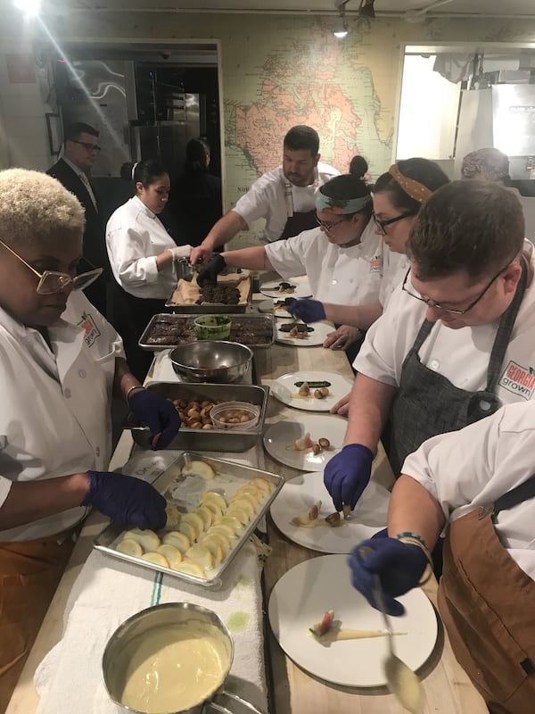 This was the scene at the Georgia Grown dinner in New York City. “To watch a team of chefs work together to plate an intricate dish is a sight to behold,” says AJC dining editor Ligaya Figueras. “It is an intricate dance as a plate moves down the line, each person adding the next component, with absolute exactness, striving to create a dish that began as an idea in someone’s head.” LIGAYA FIGUERAS / LFIGUERAS@AJC.COM