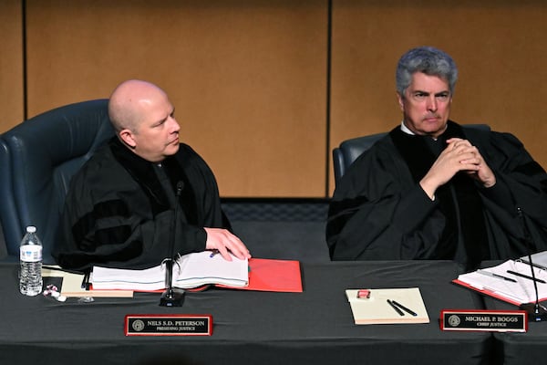 Presiding Justice Nels Peterson (left) speaks as Chief Justice Michael Boggs listens during oral arguments in an appeal of State Election Board rules on Wednesday in Cartersville. 