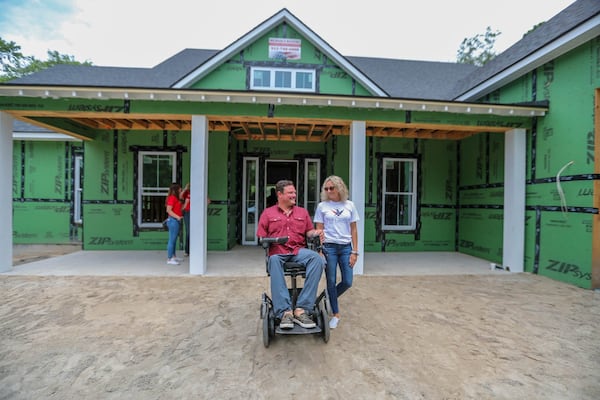 1st Sgt. Ryan Davis and his wife Asia walk outside the new home being constructed for them in Richmond Hill by the Gary Sinise Foundation.