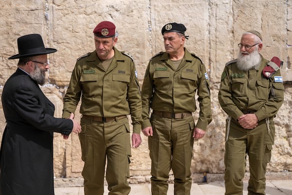 Israel's incoming military chief of staff, Lt. Gen. Eyal Zamir, second right, stands with outgoing chief Lt. Gen. Herzi Halevi, second left and eyal krim ,right, Shmuel Rabinovitch, left in the Western Wall ,the the holiest site where Jews can pray, in Jerusalem's Old City on Wednesday, March 5, 2025. (AP Photo/Ohad Zwigenberg)