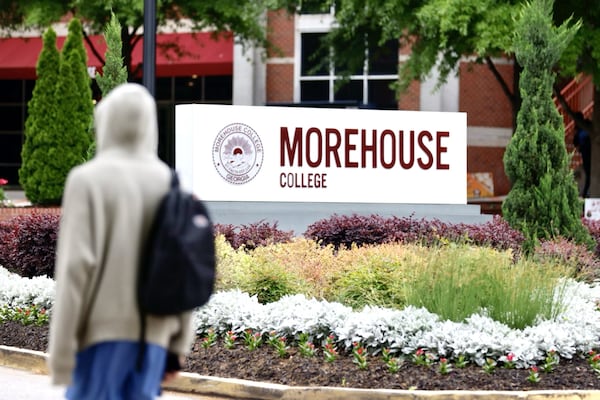 A student walks by a Morehouse College sign in Atlanta on April 24, 2024. (Miguel Martinez/AJC)