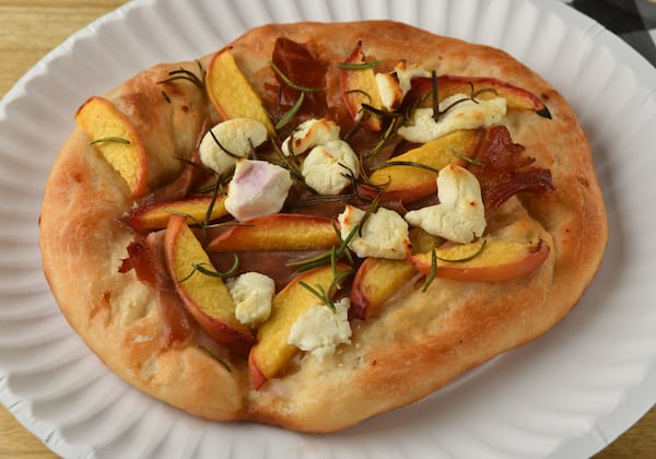 For a dish that your guests will remember, make Peach, Prosciutto and Goat Cheese Pizza. (Styling by Susan Puckett / Chris Hunt for the AJC)