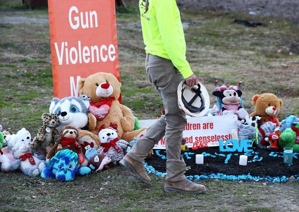 Former fighter Gage Scarborough visits the memorial for 6-month-old Grayson Fleming-Gray outside the Food Mart where he was shot and killed in a drive-by shooting on Monday, Jan. 30, 2022, in Atlanta.  “Curtis Compton / Curtis.Compton@ajc.com”