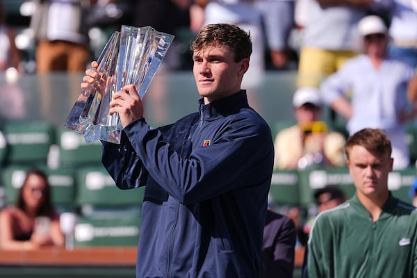 Jack Draper, of Britain, holds the winner's trophy at the BNP Paribas Open tennis tournament Sunday, March 16, 2025, in Indian Wells, Calif. (AP Photo/Mark J. Terrill)