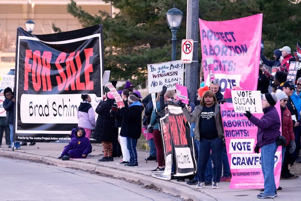 Protesters gather outside the Marquette Lubar Center before a Wisconsin Supreme Court debate between candidates Brad Schimel and Susan Crawford Wednesday, March 12, 2025, in Milwaukee. (AP Photo/Morry Gash)