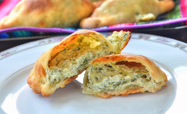 These spinach-cheese empanadas include mozzarella, feta and part-skim ricotta cheeses. STYLING BY LESLY SOBEL / CONTRIBUTED BY CHRIS HUNT PHOTOGRAPHY