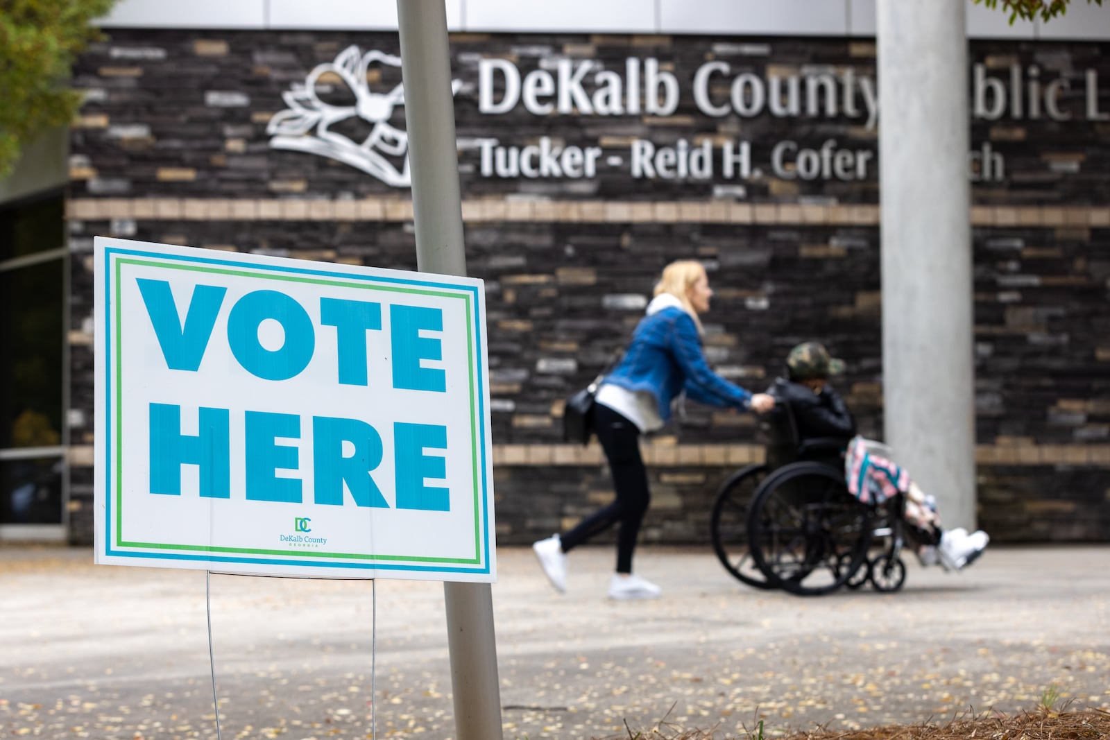 People go to the polling site at Tucker-Reid H. Cofer Library on the last day of early voting.