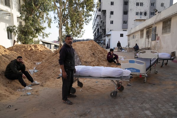 The bodies of Palestinians killed in an Israeli army airstrikes are brought to Shifa hospital in Gaza City, Tuesday, March 18, 2025. (AP Photo/Abdel Kareem Hana)