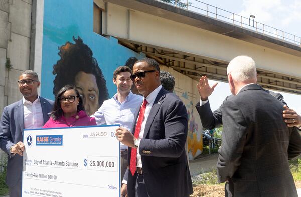 (From left) Assistant Secretary of Transportation for Transportation Policy Christopher Coes, Congresswoman Nikema Williams, Sen. Jon Ossoff, and Atlanta Beltline, Inc. CEO Clyde Higgs, hold up the check for the Atlanta’s Beltline receiving a $25M construction grant on Mayson St. on Monday, July 24, 2023 in Atlanta. (Michael Blackshire / Michael.blackshire@ajc.com)