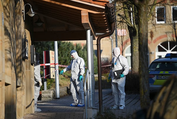 Crime scene investigators arrive on the scene Friday after a shooting left six people dead in the German town of Rot am See