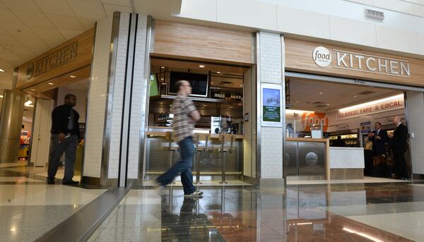 June 24, 2014 Atlanta - Airport travelers walk past one of newest additions, Food Network Kitchen, in Concourse D, Hartsfield-Jackson Atlanta International Airport on Tuesday, June 24, 2014. Hartsfield-Jackson and Delaware North celebrate the newest additions to Concourse D, including local favorites GrindHouse Killer Burgers and Yoforia, and national brands 40/40 Club and Food Network Kitchen. HYOSUB SHIN / HSHIN@AJC.COM