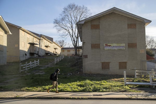 A school-aged boy walks along Delmar Lane NW, near the boarded up and permanently closed Sierra Ridge Apartments in Atlanta’s west side, Wednesday, January 22, 2020. The apartments, a 28-building property, were ordered to be demolished on April 30, 2018 after a Atlanta Municipal Court judge ruled that the property owners failed to prove the property fit for human habitation. “We hope other irresponsible property owners will take notice and work to provide clean, respectable housing for its residents,” Atlanta Police Chief Erika Shields said in a statement. The apartment complex is located within the Harper-Archer school district. (ALYSSA POINTER/ALYSSA.POINTER@AJC.COM)