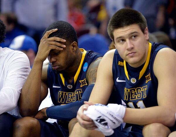 West Virginia's BillyDee Williams, left, and Nathan Adrian watch form the bench during the second half of the team's college basketball game against Kentucky in the NCAA men's tournament regional semifinals, Thursday, March 26, 2015, in Cleveland. (AP Photo/David Richard) This is how it feels to smack into Kentucky. (AP photo/David Richard)