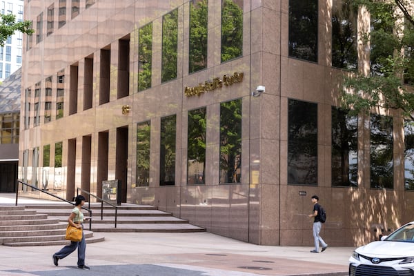 People walk past the Georgia-Pacific building in Atlanta on Wednesday, Sept. 18, 2024. Georgia-Pacific is converting their office tower in downtown Atlanta into a 51-story mixed-use building. (Arvin Temkar/AJC)