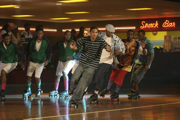 Double Duty: Actors Pierpont Greer (from left), Kenya Tyson, Hakeem Agele and James Jones double for the principals during a scene with the “Preps” (background) during filming of a Warner Bros. movie produced by music impresario Dallas Austin and directed by Chris Robinson shot at Cascade Family Skating Rink in Cascade. SEAN DRAKES/Special