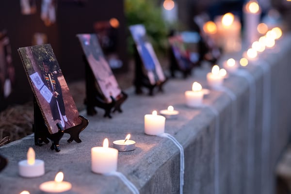 Candles line the wall before a memorial service for Kyle Gregory at Brookwood High School on July 24, 2020. Gregory, who played football at Brookwood and then went to Georgia Southern University, was one of the younger Georgians who died of COVID-19. (Ben Gray for The Atlanta Journal-Constitution)