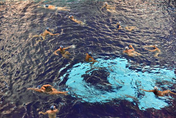 Members of Rainbow Trout Water Polo team play a mini game during practice.  (Hyosub Shin / Hyosub.Shin@ajc.com)