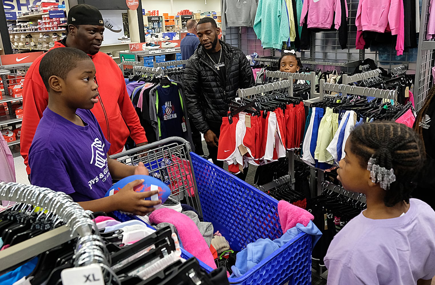 UGA Quarterback Carson Beck was on site at an Athen Academy store Sunday December 17, 2023, to give out gift cards to lucky members of area Boys and Girls Clubs. Academy Sports and Outdoors contributed $200 for each child and he kicked in $135 more of his own money to help families out. 

credit: Nell Carroll for the AJC