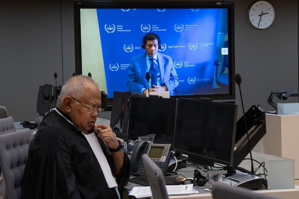 Former Philippine President Rodrigo Duterte is seen on a screen in the courtroom of the International Criminal Court (ICC) with his lawyer Salvador Medialdea seated left, in The Hague, Netherlands, Friday, March 14, 2025. (AP Photo/Peter Dejong, Pool)