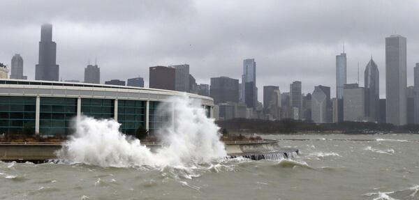 While Atlanta Democrats were trying to move on from the Democratic National Convention’s snub, Chicago hosted a celebration of the city’s victory under a cloudless sky at the Shedd Aquarium. The photo was taken during a Chicago winter when waves from Lake Michigan could be seen next to the city's Shedd Aquarium. (Charles Rex Arbogast/AP)