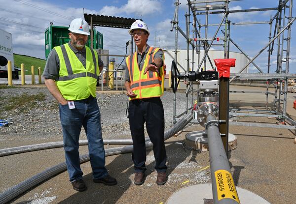 June 8, 2022 Smyrna - Mark Berry (left), vice president of environmental and natural resources for Georgia Power, and Scott Cloyd, chief engineer at Mitsubishi Power, talk at Georgia Power’s Plant McDonough-Atkinson, on Wednesday, June 8, 2022. Georgia Power conducted successful tests blending hydrogen with natural gas using existing infrastructure at the power plant. (Hyosub Shin / Hyosub.Shin@ajc.com)