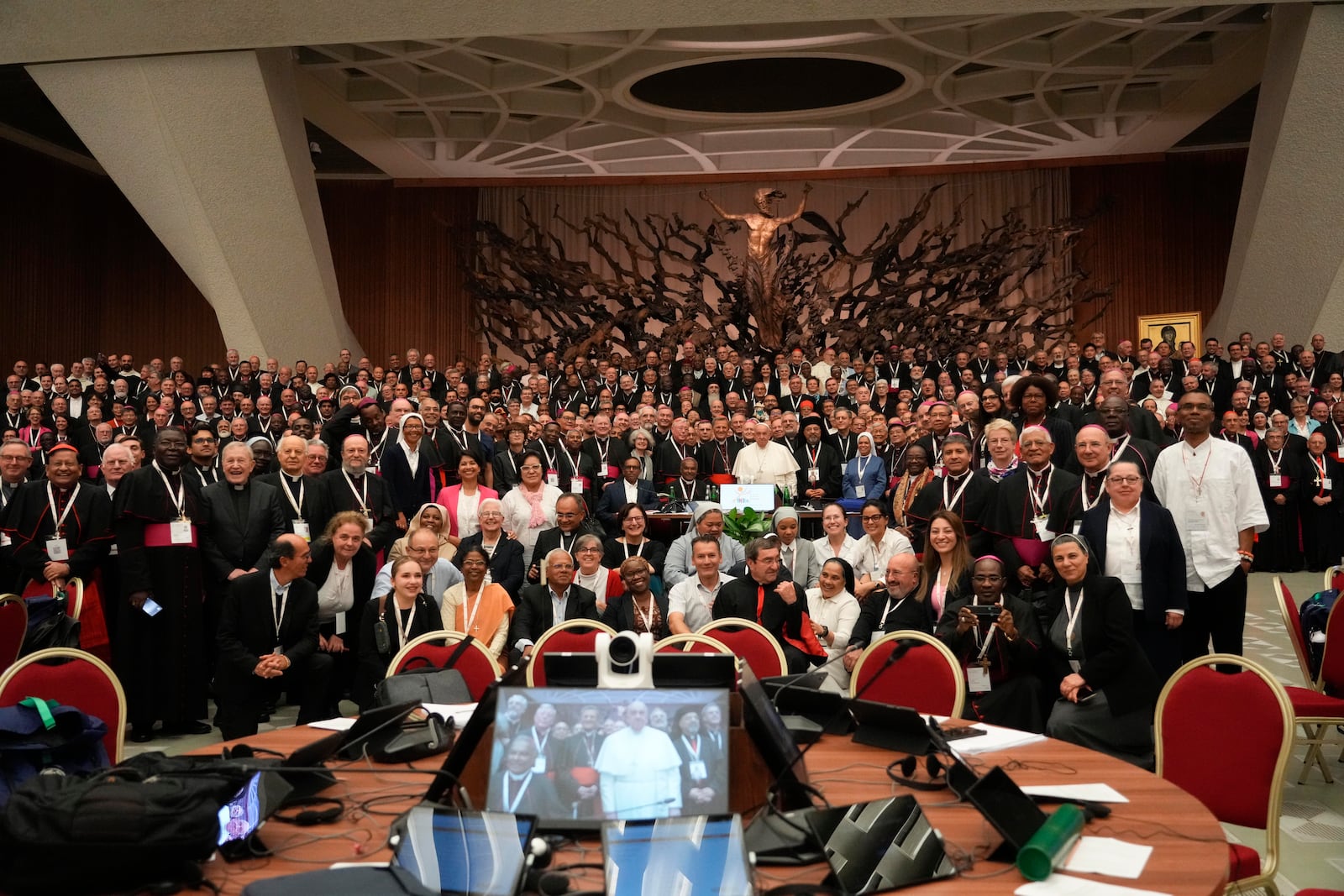 Pope Francis, background center, poses with the participants to the second session of the 16th General Assembly of the Synod of Bishops gather in the Paul VI hall, at the Vatican, Saturday, Oct. 26, 2024. (AP Photo/Gregorio Borgia)