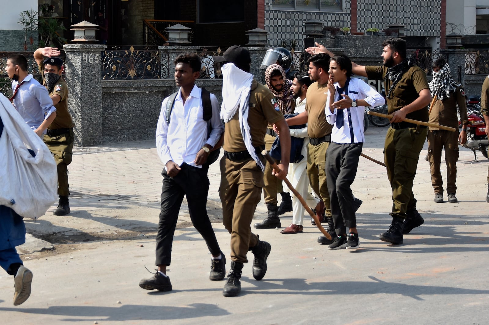 Police officers detain students following a students protest over an alleged on-campus rape in Punjab, in Rawalpindi, Pakistan, Thursday, Oct. 17, 2024. (AP Photo/W.K. Yousafzai)