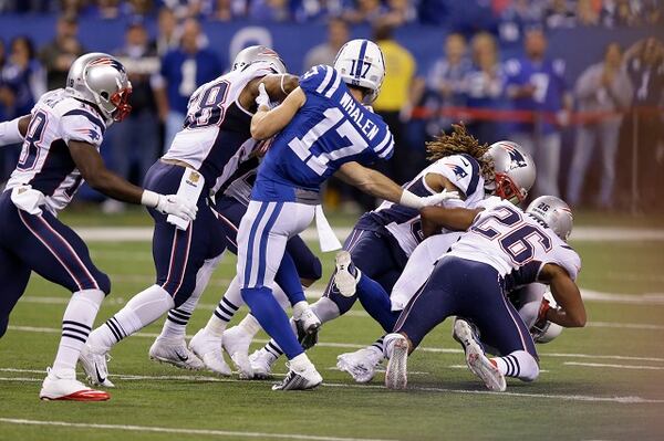 Indianapolis Colts wide receiver Griff Whalen (17) watches as Indianapolis Colts free safety Colt Anderson (32) is tackled New England Patriots running back James White (28) on a punt in the second half of an NFL football game in Indianapolis, Sunday, Oct. 18, 2015. (AP Photo/AJ Mast)