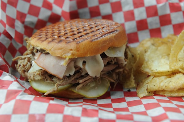 Castro sandwich with Paloma- slow smoked pork ham, fontina cheese, yellow mustard, deli dill pickles pressed on a parker house roll at Victory Sandwich Bar in Decatur. 