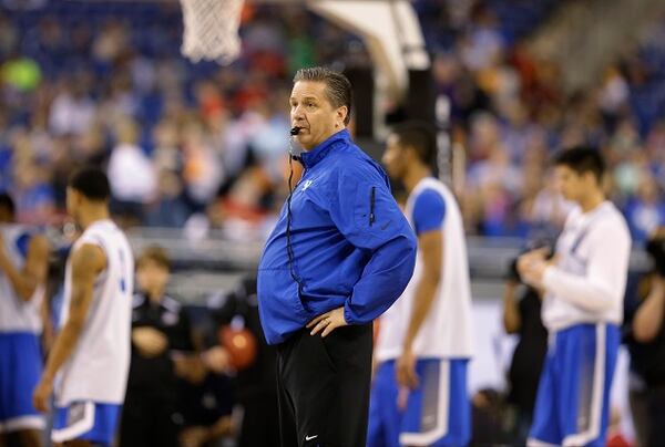 Kentucky head coach John Calipari watches over a practice session for the NCAA Final Four tournament college basketball semifinal game Friday, April 3, 2015, in Indianapolis. Kentucky plays Wisconsin on Saturday. (AP Photo/Michael Conroy) Whistling while he works: John Calipari at practice Friday. (AP photo/Michael Conroy)