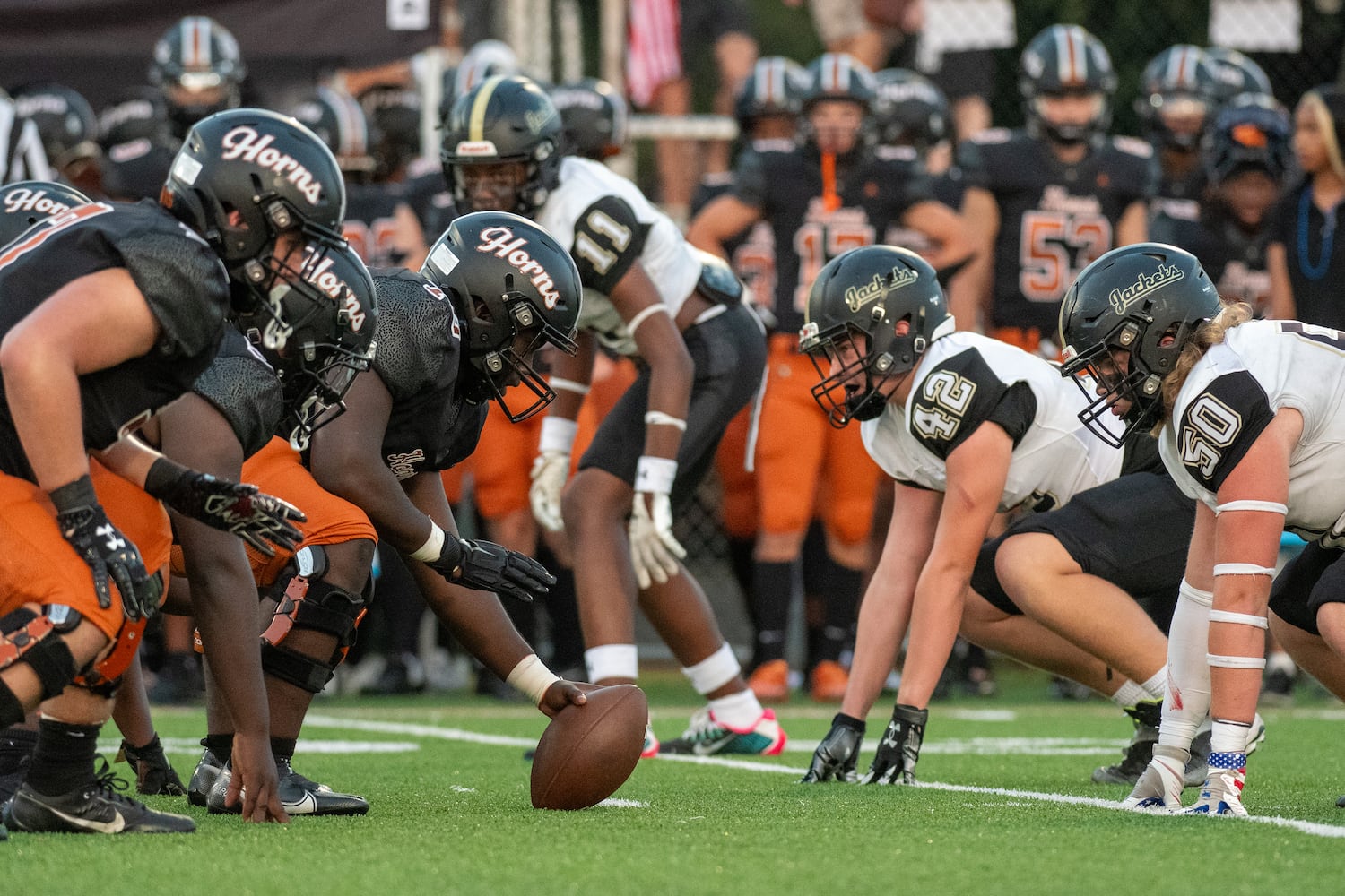 The Kell offense and the Sprayberry defense meet at the line of scrimmage before a play during Friday's game. (Jamie Spaar for the Atlanta Journal Constitution)