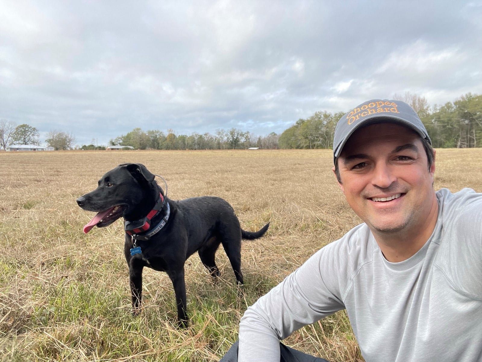 Roxie the Black Lab with her person, Amir Farokhi, preparing to plant a 2,100 tree olive grove near Adrian, Ga. (Courtesy photo)