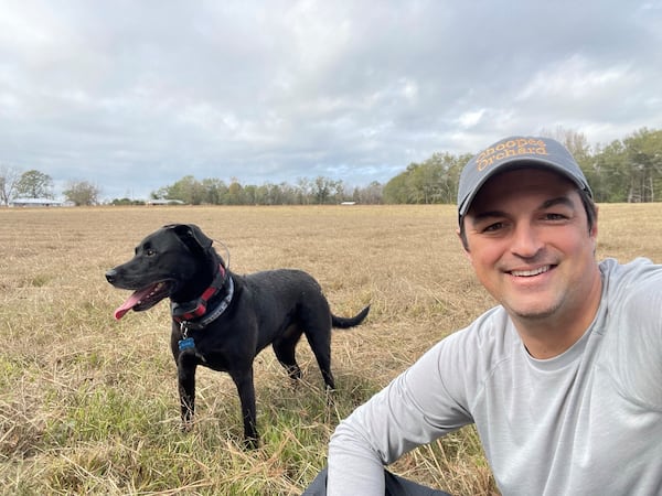 Roxie the Black Lab with her person, Amir Farokhi, preparing to plant a 2,100 tree olive grove near Adrian, Ga. (Courtesy photo)